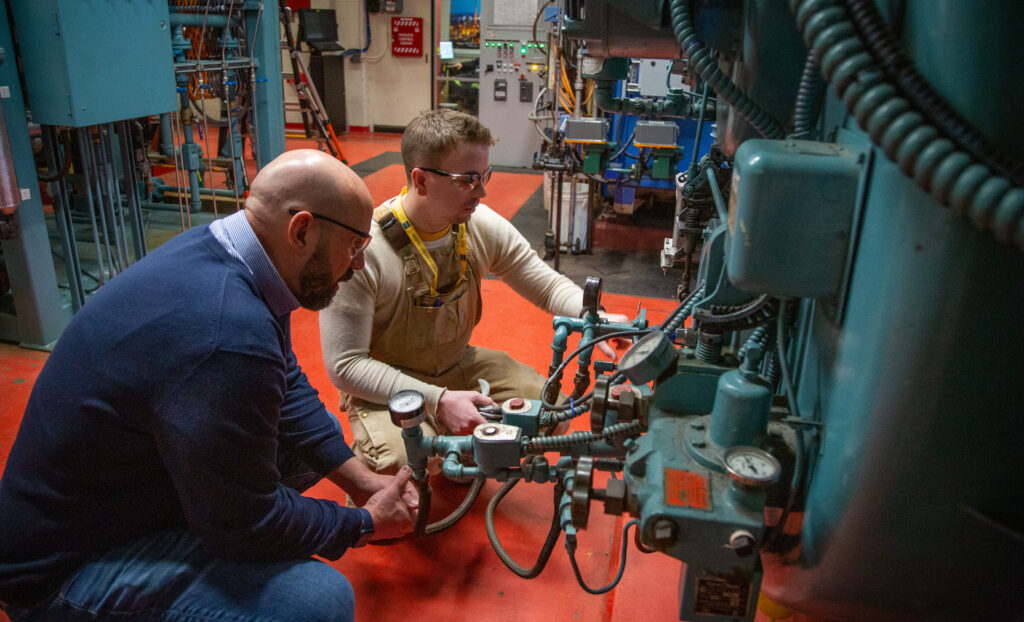 Two team members collaborating on machinery operation