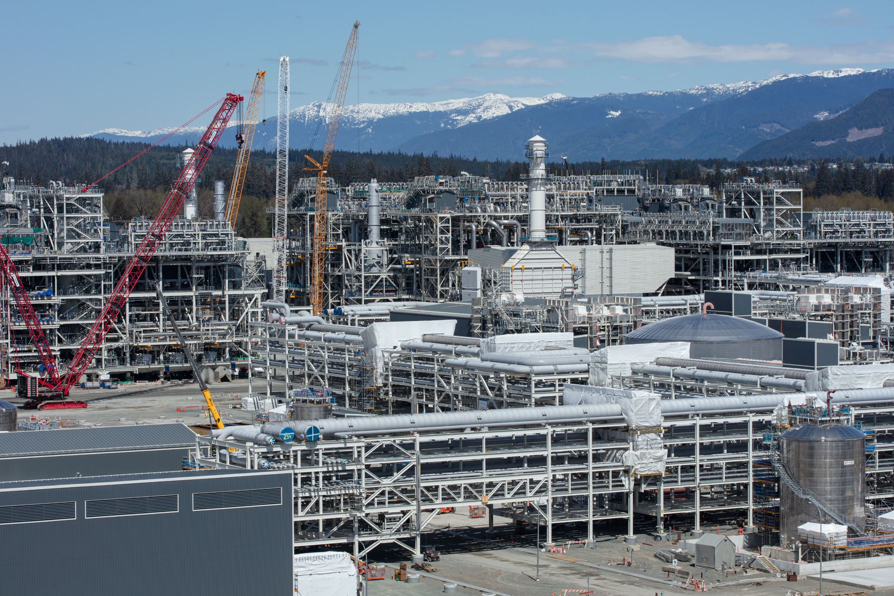 Liquefied natural gas pipelines and equipment at the LNG Canada site, showcasing infrastructure and operations