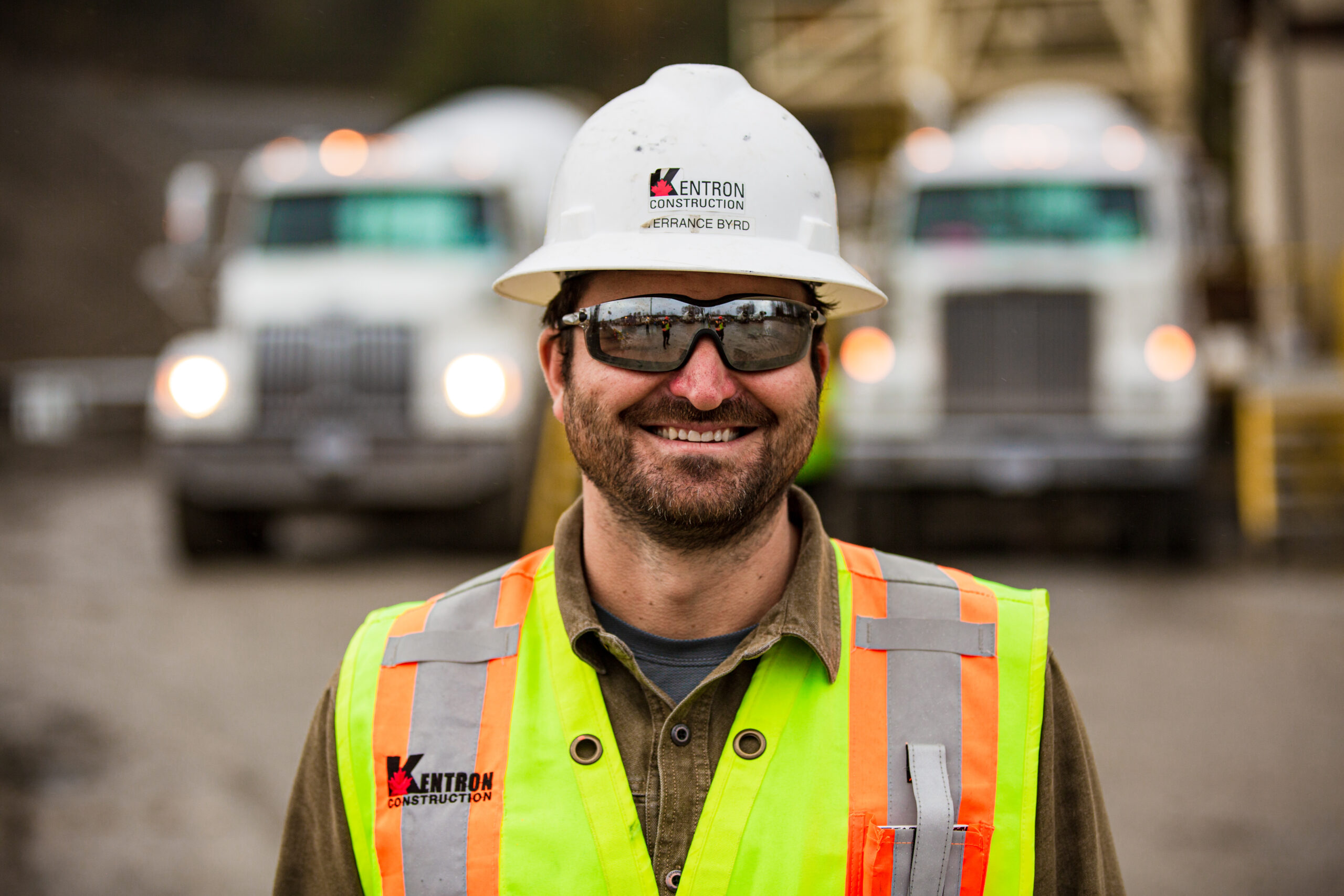 A smiling male construction worker on a job site