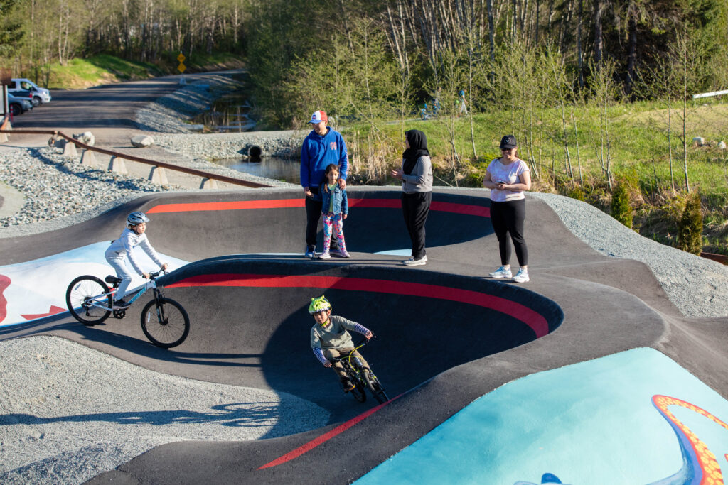 People enjoying outdoor activities at a bike and skate park